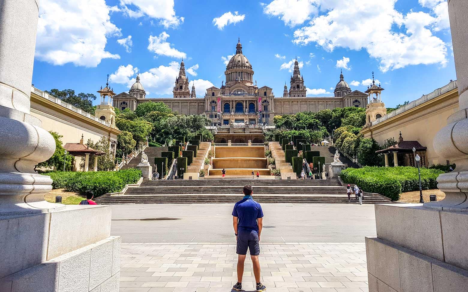 man standing in front of a museum in barcelona