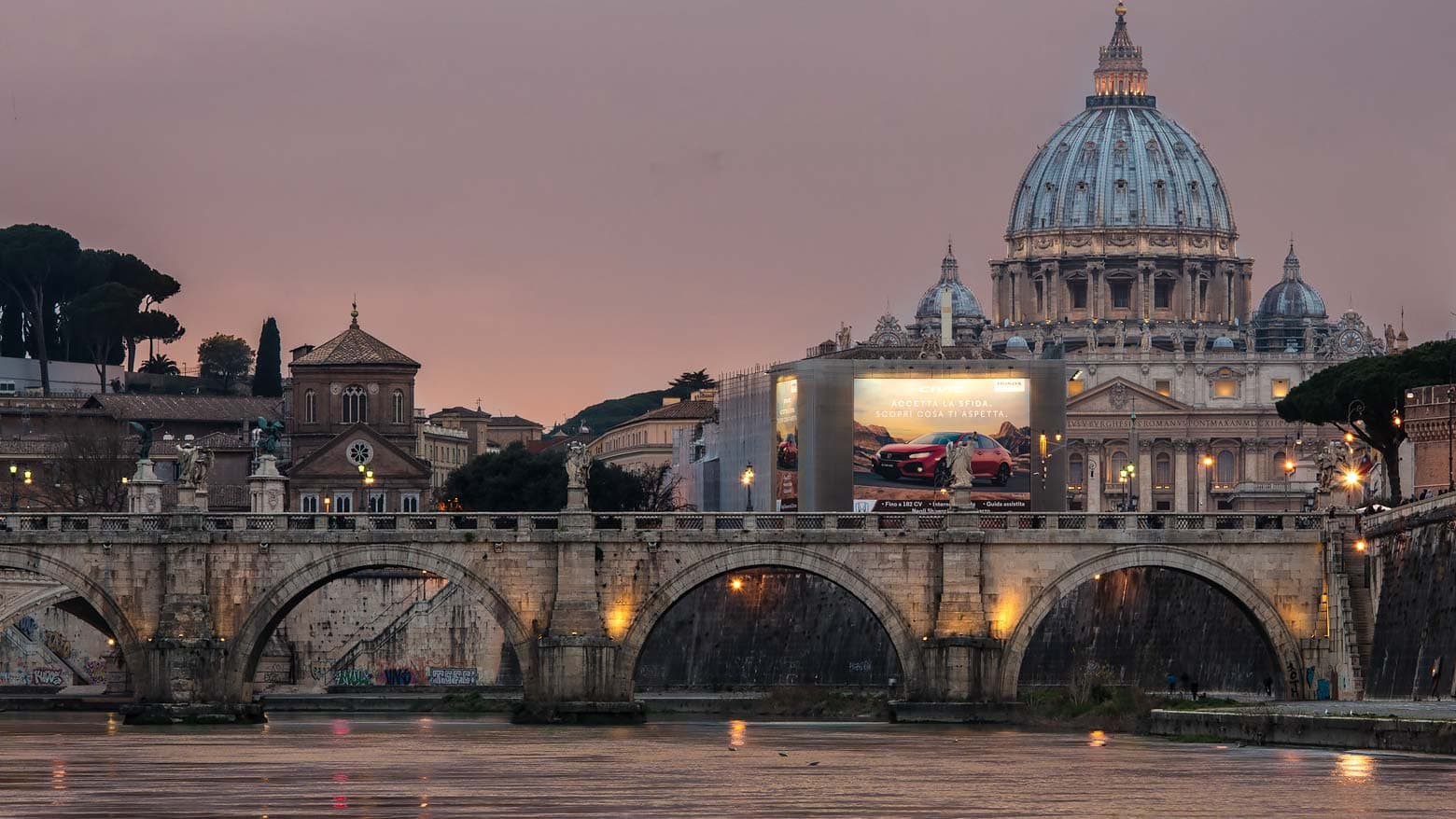 dome of the vatican city and the river Tiber on sunset