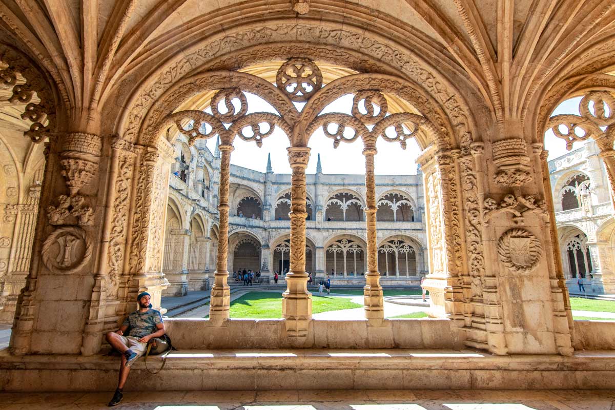 man sitting on a bench in the jeronimos monastery