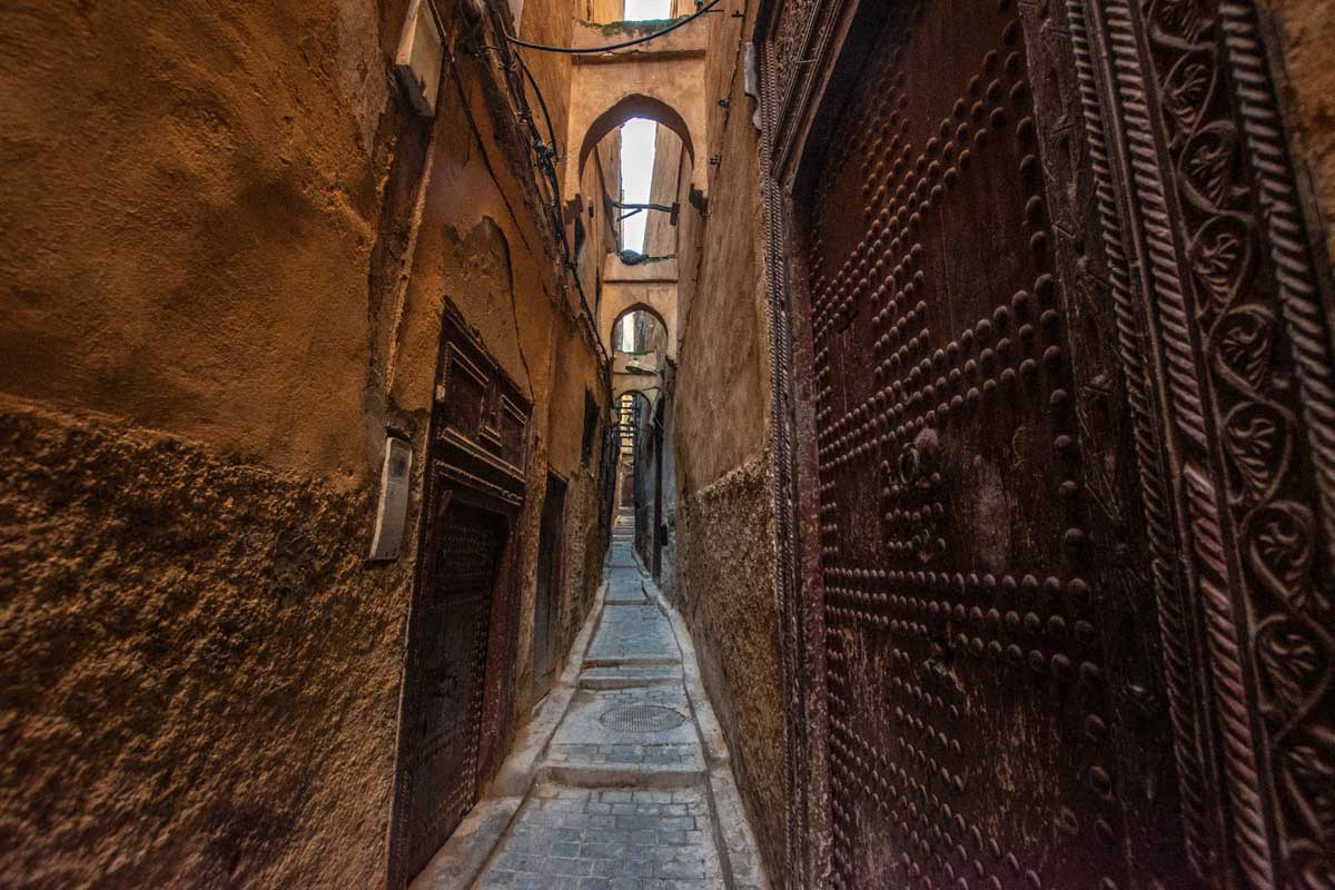 a narrow orange alley inside the authentic Fes Medina