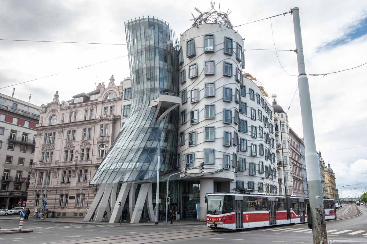 Prague's Dancing House with a tram im front