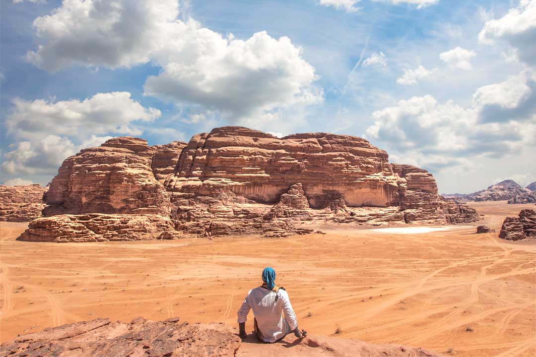 a man in front of the wadi rum desert panorama