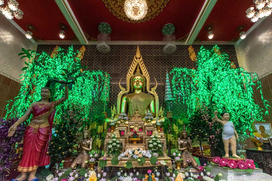 buddha-statue-with-green-lights-on-the-background