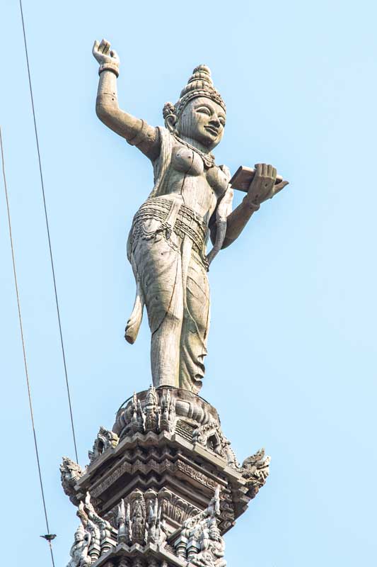 girl-holing-scripture-on-sanctuary-of-truth-pattatya-rooftop