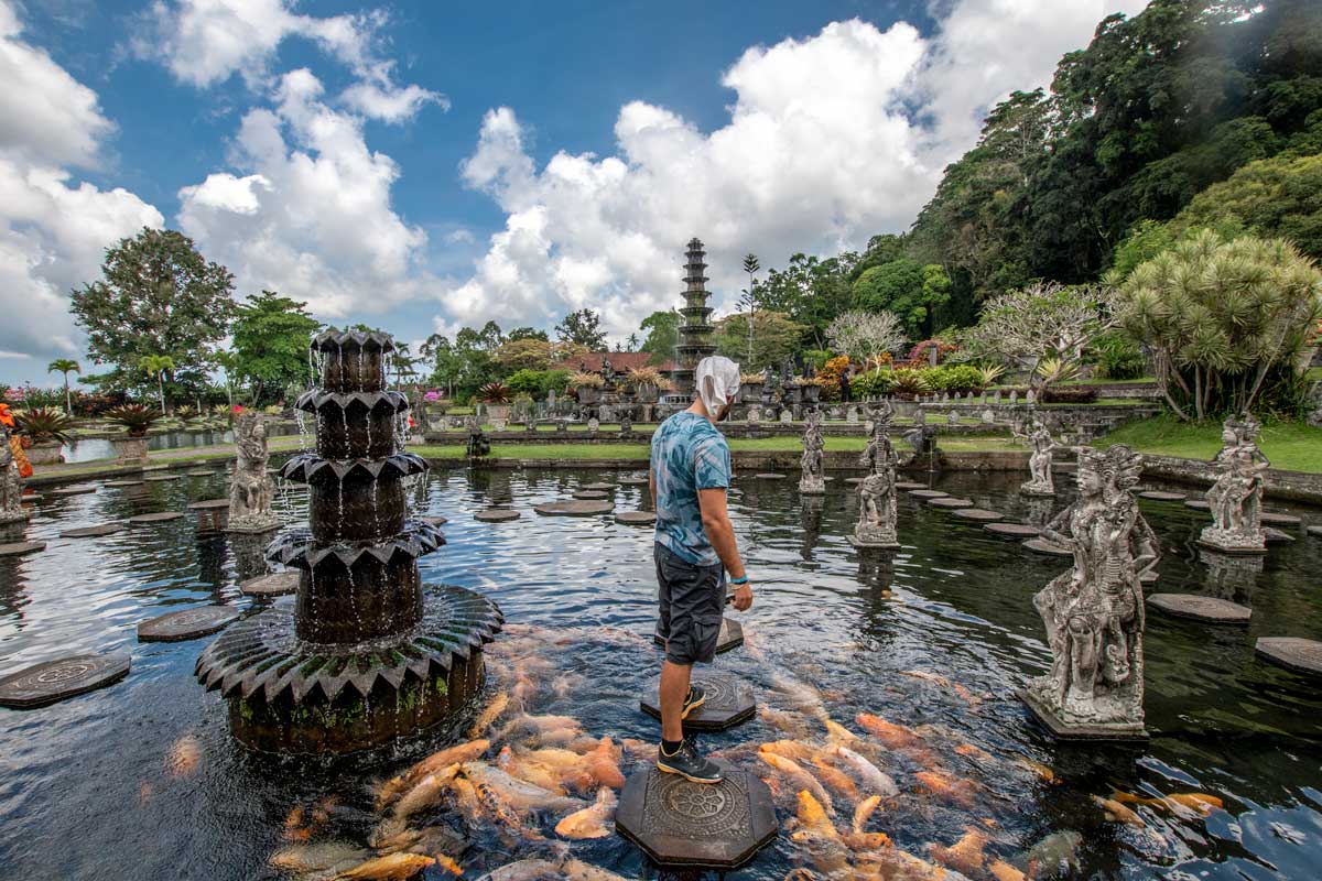 what indonesia is famous for - man taking a photo in a picturesque garden in bali