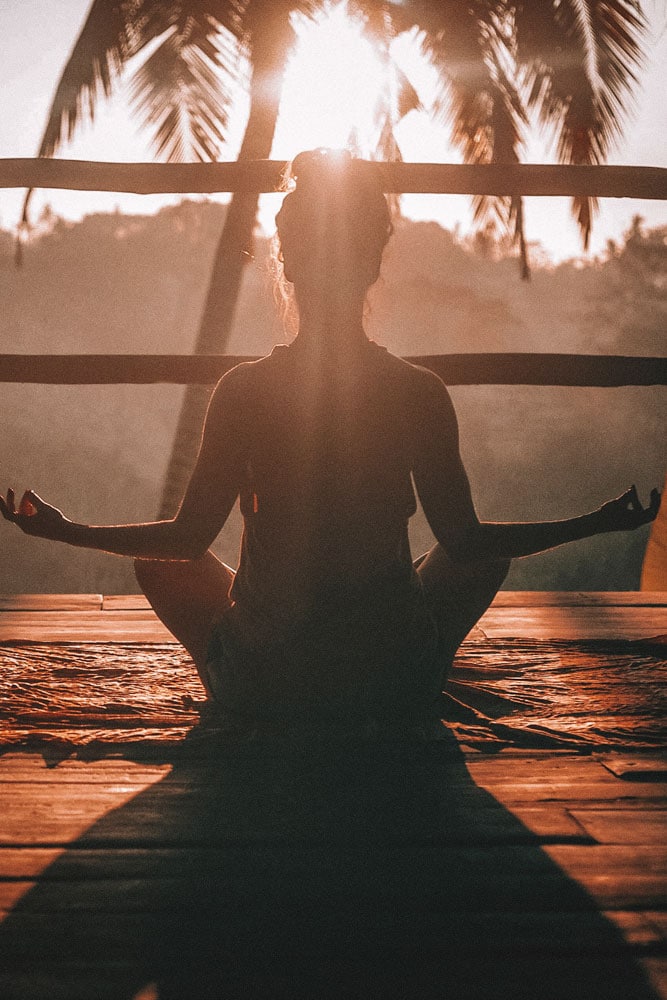 girl-doing-yoga-on-sunrise