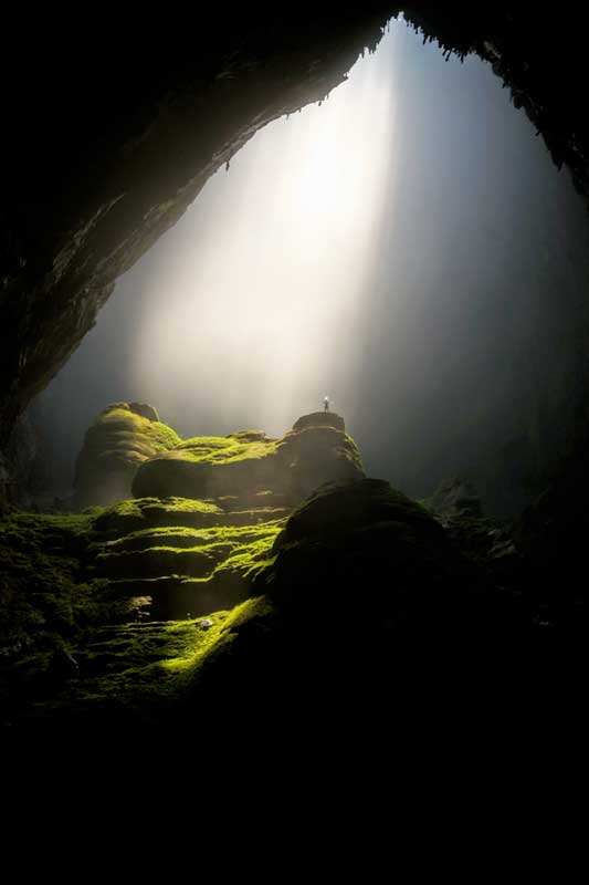 guy-standing-in-a-large-cave