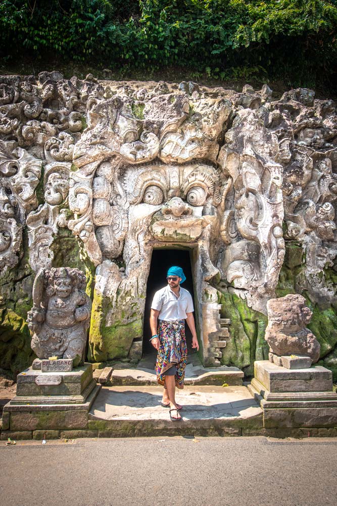 man-in-front-of-a-carved-cave