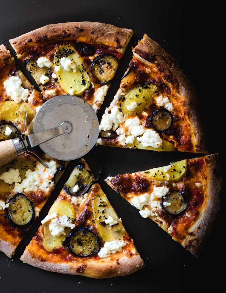 pizza-with-vegetables-on-a-black-table