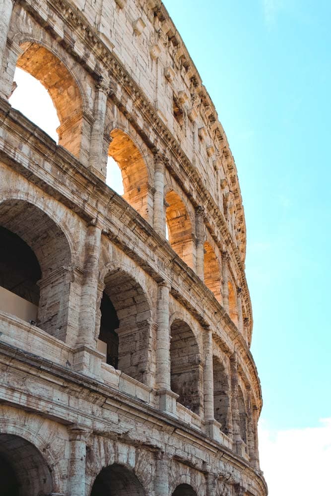 landmarks-in-italy-part-of-the-colosseum-with-baby-blue-sky