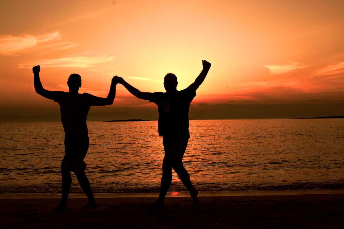 silhouettes-of-two-men-dancing-sirtaki-on-the-beach