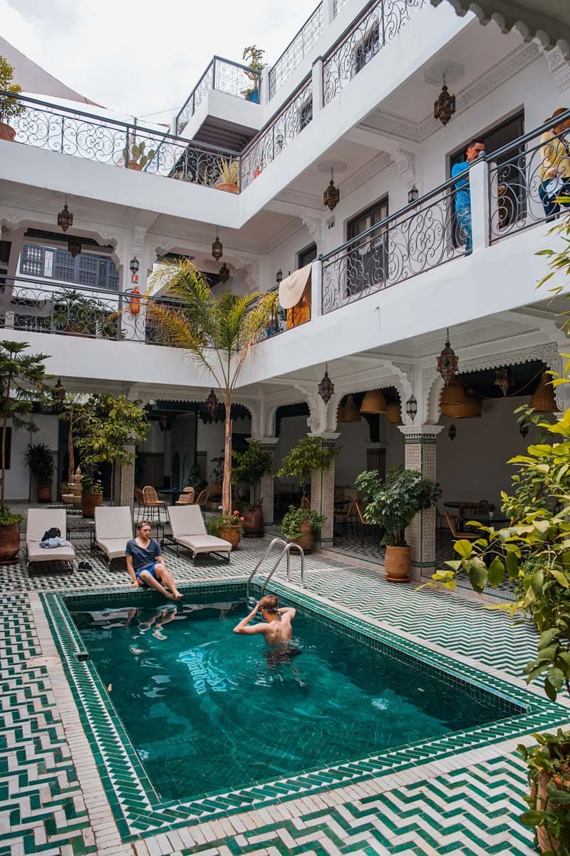 inside-yard-of-a-riad-with-a-pool-and-guest-bathing-in-it