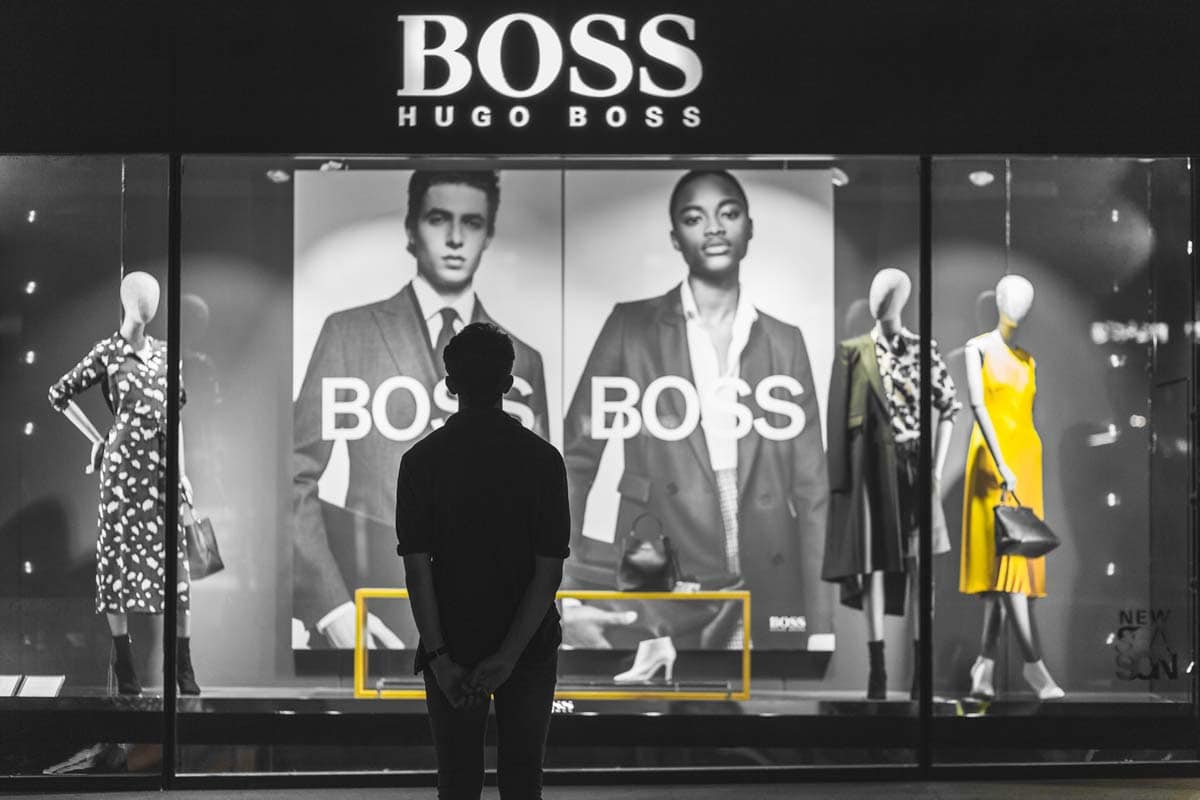 a-man-standing-in-front-of-a-hugo-boss-store