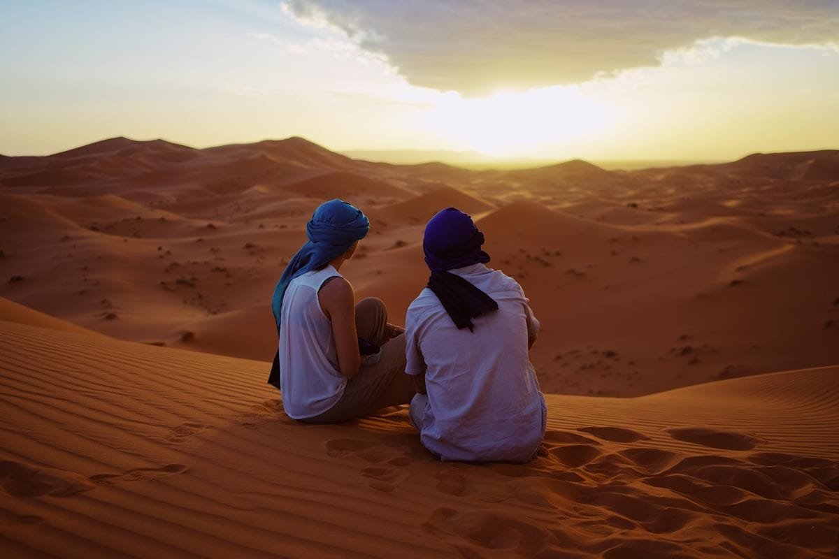 two-men-sitting-in-the-desert