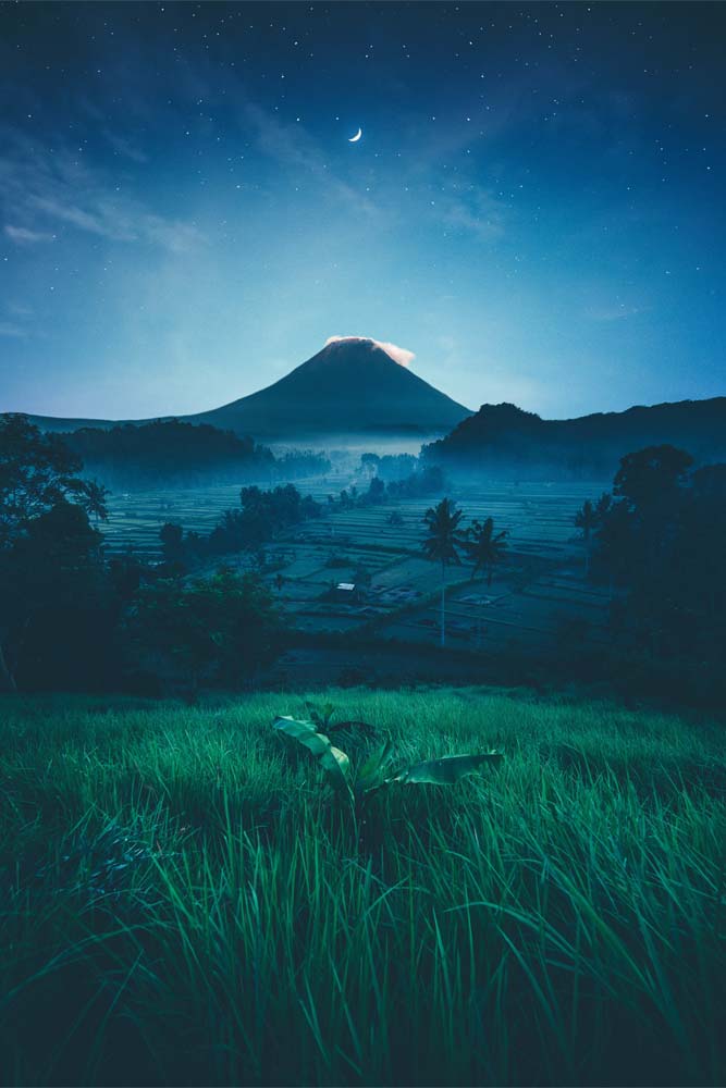 what-indonesia-is-famous-for-volcano-with-rise-farns-in-front-of-it-at-night