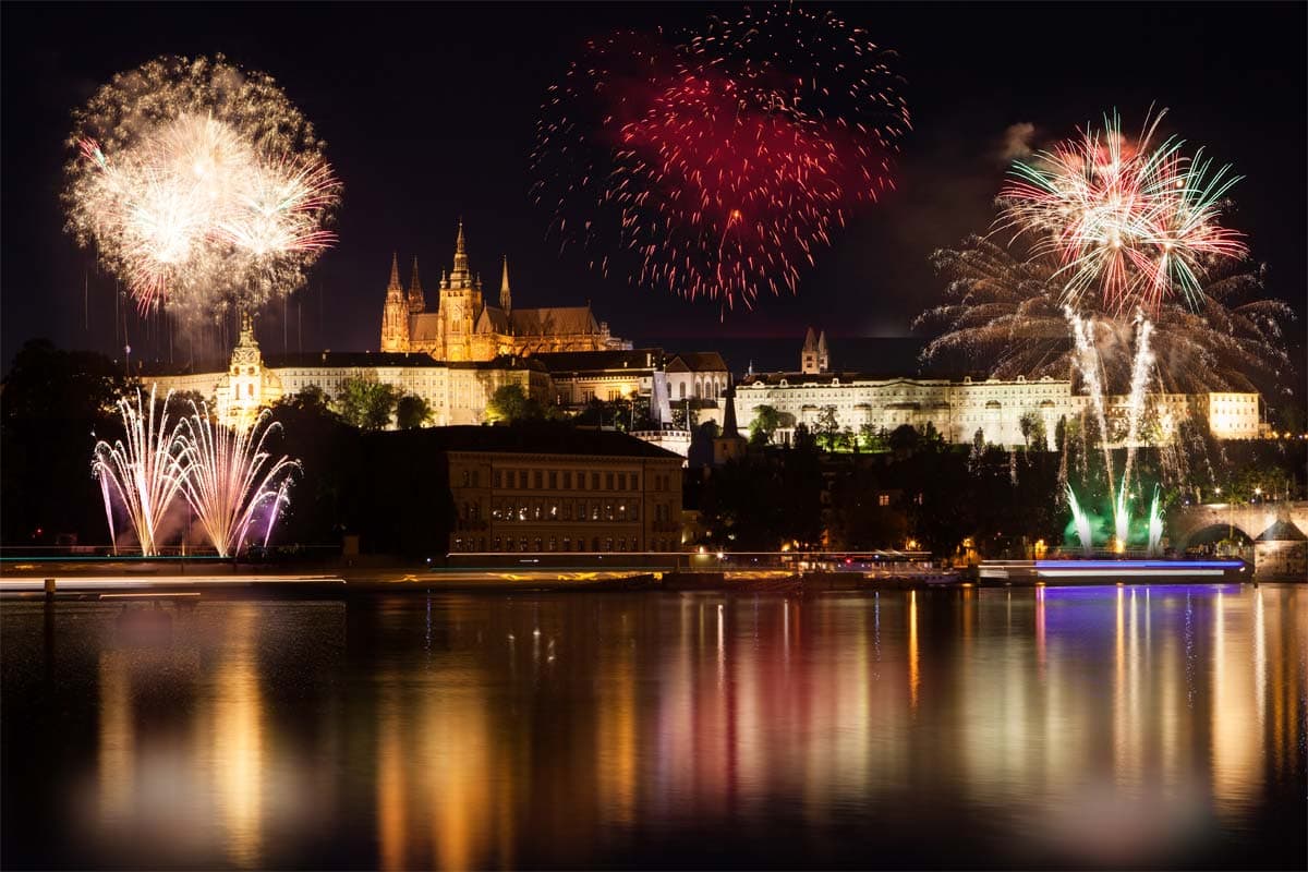 what-prague-is-known-for-charles-bridge-at-night-with-fireworks-in-the-sky