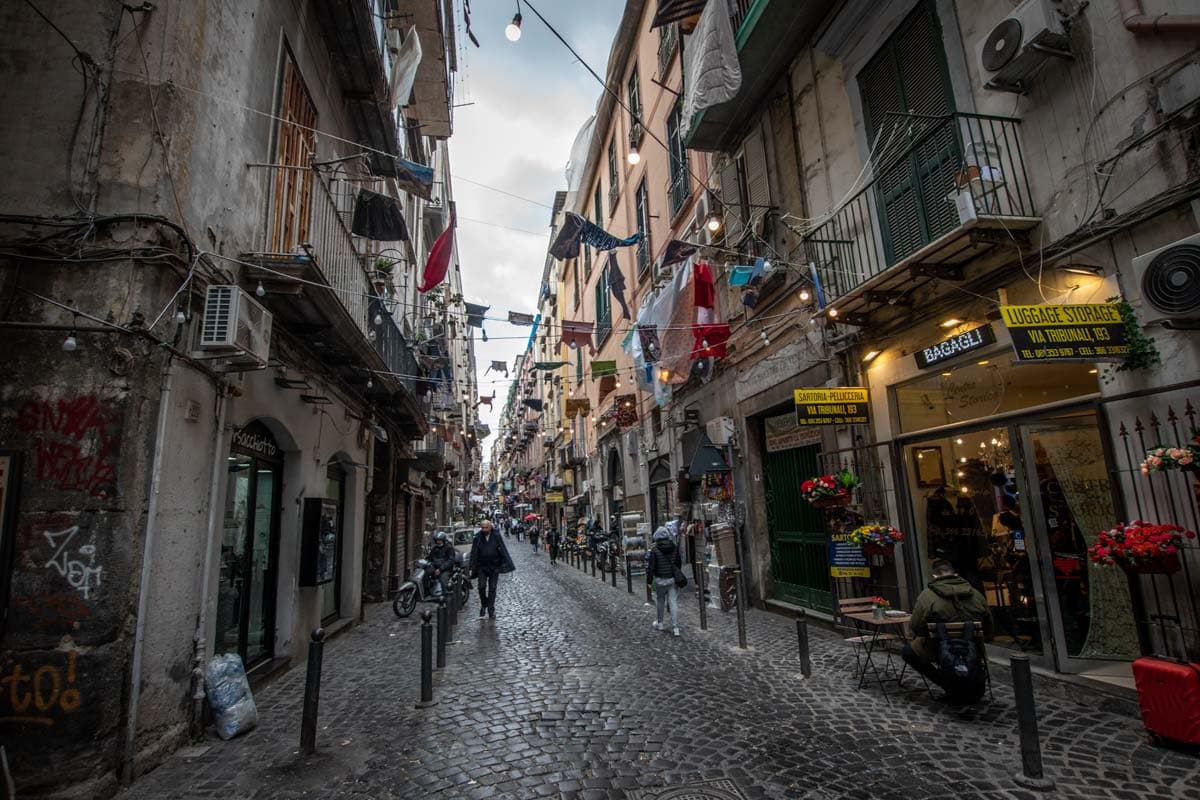 man-walking-on-a-tiny-street-in-naples
