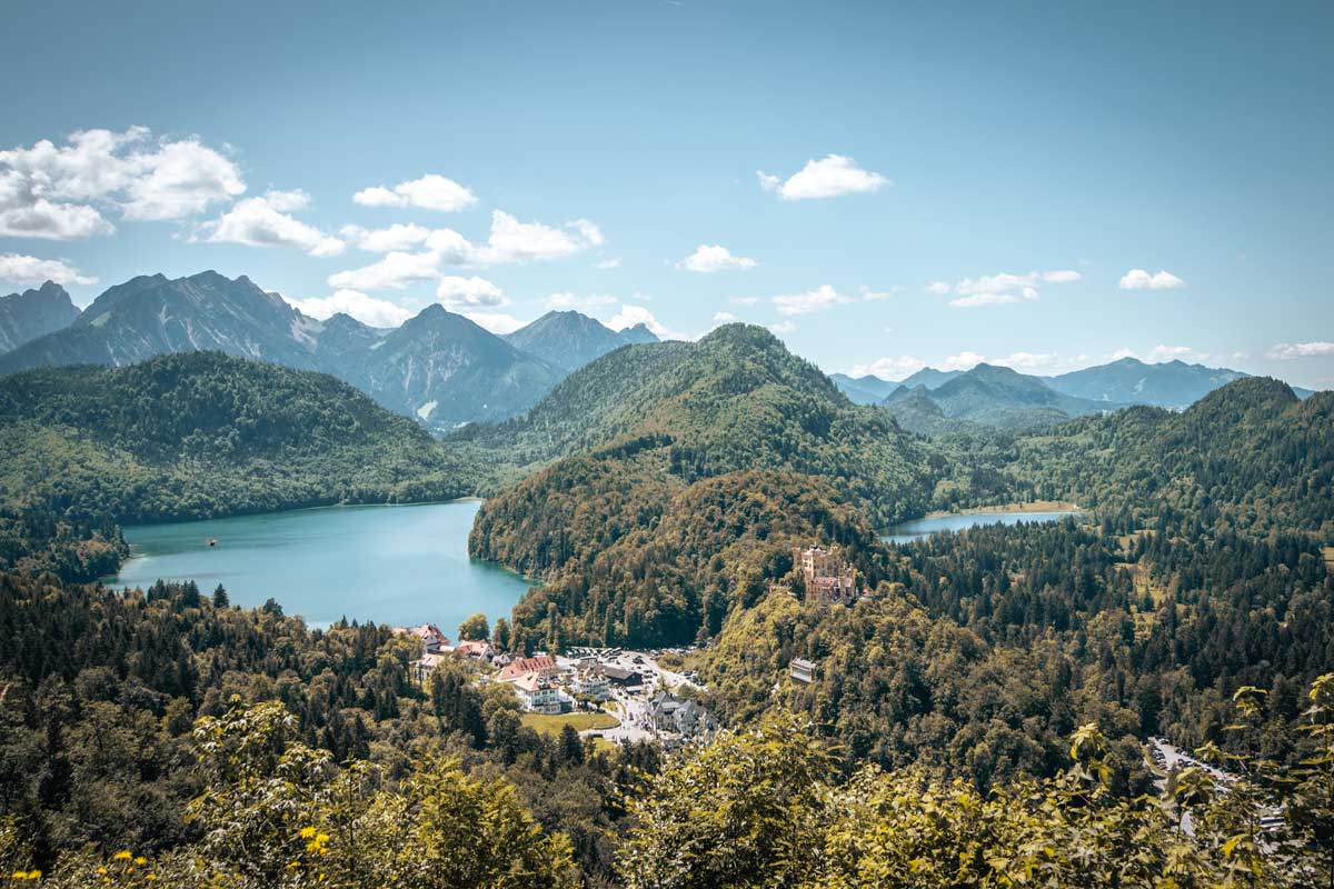 munich-to-neuschwanstein-castle-panoramic-view-of-a-castle-and-lakes