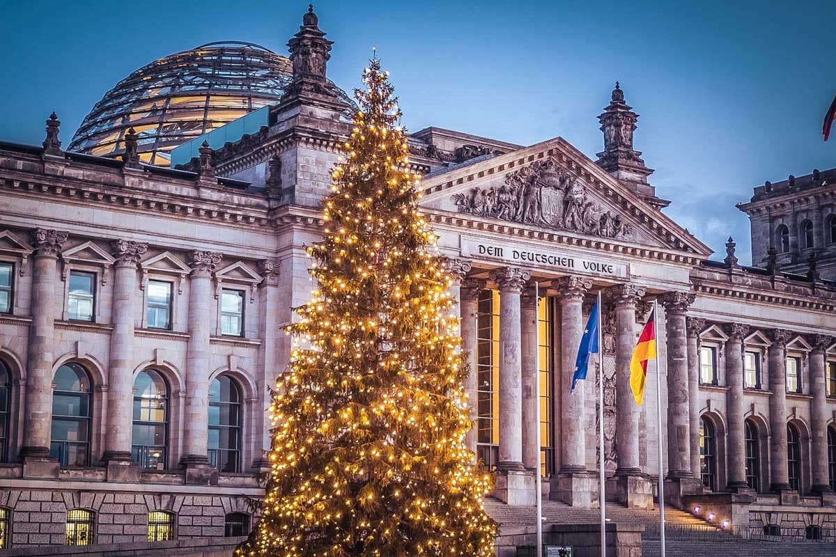 berlins-reichstag-with-a-christmas-tree-in-front